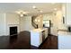 Bright kitchen area with white cabinets, an island, stainless appliances, and hardwood flooring at 340 Auburn Valley Way, Auburn, GA 30011