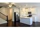Well-lit kitchen featuring an island, stainless steel appliances, white cabinetry, and hardwood floors at 340 Auburn Valley Way, Auburn, GA 30011
