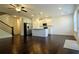 Open-concept kitchen with white cabinets, stainless steel appliances, and hardwood floors at 340 Auburn Valley Way, Auburn, GA 30011