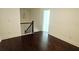 Upper landing area with dark wood floors and staircase with a dark wooden railing at 340 Auburn Valley Way, Auburn, GA 30011
