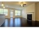 Bright living room with hardwood floors, fireplace, ceiling fan, and large windows at 340 Auburn Valley Way, Auburn, GA 30011