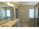 Light filled bathroom with double vanity, tub, and walk-in shower at 340 Auburn Valley Way, Auburn, GA 30011