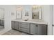 Double vanity with gray cabinets, white countertops, and modern fixtures in a bathroom at 6711 Cadence Blvd, Atlanta, GA 30328