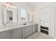 Bathroom featuring a double vanity with gray cabinets, white countertops, and modern lighting at 6711 Cadence Blvd, Atlanta, GA 30328