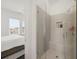 Modern bathroom featuring tiled shower and a window view, attached to the main bedroom at 6711 Cadence Blvd, Atlanta, GA 30328
