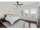 Bright and airy bedroom with dark floors, large windows, and a neutral color palette at 6711 Cadence Blvd, Atlanta, GA 30328