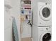 Convenient laundry room with a full-size washer and dryer, plus storage shelves and ironing board at 6711 Cadence Blvd, Atlanta, GA 30328