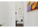 Stylish powder room featuring a pedestal sink, decorative mirror and dark floors at 6711 Cadence Blvd, Atlanta, GA 30328