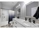Modern bathroom featuring double sinks, modern fixtures, and a shower-tub combo at 129 Prominence Ct, Canton, GA 30114