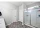 Bright bathroom features a glass-enclosed shower, tile floors, and a neutral color palette at 129 Prominence Ct, Canton, GA 30114