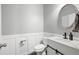 Charming powder room with wainscoting, modern vanity, and a round mirror at 129 Prominence Ct, Canton, GA 30114
