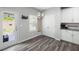 Bright breakfast nook with a modern chandelier, gray flooring, and an exterior door leading to the backyard at 129 Prominence Ct, Canton, GA 30114