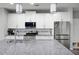 Modern kitchen with white cabinets, stainless steel appliances, island with sink, and subway tile backsplash at 129 Prominence Ct, Canton, GA 30114