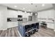 Stylish kitchen featuring white cabinets, granite countertops, stainless steel appliances, subway tile backsplash, and island with seating at 129 Prominence Ct, Canton, GA 30114