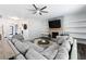 Open-concept living room with fireplace, shelving, and modern decor at 129 Prominence Ct, Canton, GA 30114