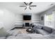 Bright living room with fireplace, floating shelves, and comfortable seating at 129 Prominence Ct, Canton, GA 30114