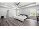 Large main bedroom boasts tray ceilings, gray flooring, and windows offering picturesque views at 129 Prominence Ct, Canton, GA 30114