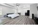 Expansive main bedroom with tray ceilings, gray flooring, and abundant natural light from multiple windows at 129 Prominence Ct, Canton, GA 30114
