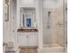 Well-lit bathroom featuring a walk-in shower and vanity with granite countertop at 1717 N Decatur Ne Rd # 303, Atlanta, GA 30307