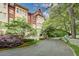 An exterior view of an impressive brick and stone building surrounded by lush landscaping at 1717 N Decatur Ne Rd # 303, Atlanta, GA 30307