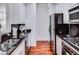 A galley kitchen with black granite countertops, white cabinets, and hardwood floors at 1717 N Decatur Ne Rd # 303, Atlanta, GA 30307