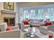 A spacious living room with ample seating, a fireplace, and bright windows overlooking greenery at 1717 N Decatur Ne Rd # 303, Atlanta, GA 30307