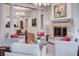 An open-concept living room with a fireplace, columns, and a view into the dining area at 1717 N Decatur Ne Rd # 303, Atlanta, GA 30307
