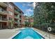 Inviting outdoor pool with lounge chairs and lush greenery in a brick building at 1717 N Decatur Ne Rd # 303, Atlanta, GA 30307