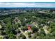 Aerial view of a tree lined neighborhood with a view of the city skyline in the distance at 4824 Dunwoody Station Dr, Atlanta, GA 30338