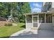This backyard features a screened porch, patio, green lawn, and play set at 4824 Dunwoody Station Dr, Atlanta, GA 30338