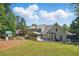 Expansive backyard view with a screen porch, patio, playset, and lush lawn at 4824 Dunwoody Station Dr, Atlanta, GA 30338