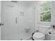 Elegant glass enclosed shower showcasing a tiled surround, built-in bench, and window at 4824 Dunwoody Station Dr, Atlanta, GA 30338
