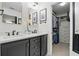 Bathroom vanity with double sinks, white countertops and view into walk-in closet at 4824 Dunwoody Station Dr, Atlanta, GA 30338