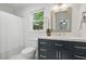 Well-lit bathroom featuring a blue vanity, white countertop, and classic shower curtain at 4824 Dunwoody Station Dr, Atlanta, GA 30338