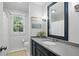 Well-lit bathroom features a modern vanity, framed mirror, and a window at 4824 Dunwoody Station Dr, Atlanta, GA 30338