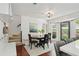 Light-filled dining area with a bay window, staircase, and hardwood floors at 4824 Dunwoody Station Dr, Atlanta, GA 30338
