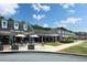 Outdoor seating with umbrellas at a restaurant in a retail center at 4824 Dunwoody Station Dr, Atlanta, GA 30338