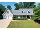 Charming traditional home featuring a two-car garage and inviting front porch with lovely landscaping at 4824 Dunwoody Station Dr, Atlanta, GA 30338