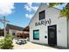 A charming brick building with a black door and picnic tables outside at 4824 Dunwoody Station Dr, Atlanta, GA 30338