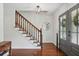 Foyer featuring staircase with wood banister, hardwood floors, and a front door at 4824 Dunwoody Station Dr, Atlanta, GA 30338