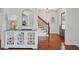 Elegant foyer with hardwood floors, decorative cabinet, arched mirror, and staircase at 4824 Dunwoody Station Dr, Atlanta, GA 30338