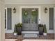 Stylish front door with sidelights, brick flooring, and decorative wreaths, creating curb appeal at 4824 Dunwoody Station Dr, Atlanta, GA 30338