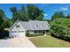 Charming home featuring manicured lawn, two-car garage, and inviting front porch at 4824 Dunwoody Station Dr, Atlanta, GA 30338
