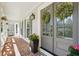 Inviting front porch with brick flooring, potted flowers and front door with decorative wreath at 4824 Dunwoody Station Dr, Atlanta, GA 30338