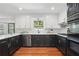 Bright kitchen with stainless steel appliances, black and white cabinets, and hardwood floors at 4824 Dunwoody Station Dr, Atlanta, GA 30338