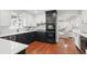 Stylish kitchen with stainless steel appliances, black and white cabinets, and hardwood floors at 4824 Dunwoody Station Dr, Atlanta, GA 30338