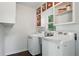 Bright laundry room with modern washer, dryer, and storage space at 4824 Dunwoody Station Dr, Atlanta, GA 30338