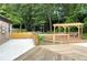 Inviting outdoor patio with pergola, picnic tables, and a wooden deck, ideal for relaxation and gatherings at 4824 Dunwoody Station Dr, Atlanta, GA 30338