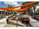 A spacious outdoor dining area with tables and chairs under colorful awnings at 4824 Dunwoody Station Dr, Atlanta, GA 30338