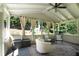 Relaxing sunroom with wicker chairs and views of the lush backyard and playground at 4824 Dunwoody Station Dr, Atlanta, GA 30338
